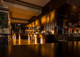 Stylish modern restaurant interior with warm lighting, elegant design, and luxurious ambiance at night.